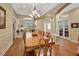 Formal dining room boasts hardwood floors, coffered ceilings, and large wooden table at 1504 Ginger Snap, Deland, FL 32720