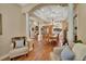 Elegant dining room with a large table, chandelier lighting, and decorative columns at 1504 Ginger Snap, Deland, FL 32720