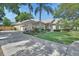 Charming home featuring a well-manicured lawn, a three car garage, and mature trees at 1504 Ginger Snap, Deland, FL 32720