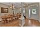 Bright foyer features a decorative glass front door, wood floors, and columns at 1504 Ginger Snap, Deland, FL 32720