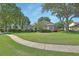 Well-maintained front yard with lush green grass, mature trees, and attractive landscaping at 1504 Ginger Snap, Deland, FL 32720