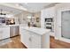 Gourmet kitchen with white cabinetry, stainless steel appliances, and center island at 1504 Ginger Snap, Deland, FL 32720