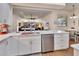 Open concept kitchen features stainless appliances, white cabinets, and center island at 1504 Ginger Snap, Deland, FL 32720