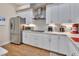 This kitchen features white cabinets, stainless steel appliances, and subway tile backsplash at 1504 Ginger Snap, Deland, FL 32720
