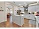 Bright kitchen features an island, stainless appliances, and white cabinets with granite countertops at 1504 Ginger Snap, Deland, FL 32720