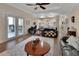 Open-concept living room with hardwood floors, comfortable seating, and access to an outdoor patio at 1504 Ginger Snap, Deland, FL 32720