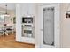 Well-organized pantry with designer glass door and adjacent to stainless steel microwave/oven at 1504 Ginger Snap, Deland, FL 32720