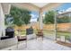 Inviting screened-in patio with tiled flooring, comfortable seating, and a view of the fenced backyard at 1504 Ginger Snap, Deland, FL 32720