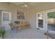 Covered patio featuring tiled floors, a ceiling fan, a table and chairs, and access to the backyard at 1504 Ginger Snap, Deland, FL 32720