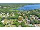 Aerial view of a home surrounded by trees in a neighborhood near a lake, highlighting its serene location at 1534 Center St, Deland, FL 32720