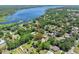 Aerial view of a home near a river surrounded by lush greenery and other homes in a peaceful neighborhood at 1534 Center St, Deland, FL 32720