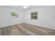 A bright bedroom with wood-look floors and natural light streaming in from two windows at 1534 Center St, Deland, FL 32720