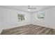 Bedroom featuring wood-look floors and two windows providing natural light at 1534 Center St, Deland, FL 32720