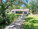 Charming single-story home featuring a well-manicured lawn and a long concrete driveway at 1534 Center St, Deland, FL 32720