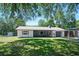 Charming single-story home boasting a well-manicured lawn and mature trees at 1534 Center St, Deland, FL 32720