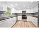 Bright kitchen featuring stainless steel appliances and stone countertops at 1534 Center St, Deland, FL 32720