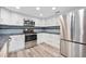 Bright kitchen featuring stainless steel appliances and stone countertops at 1534 Center St, Deland, FL 32720