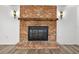 Charming brick fireplace with a wooden mantle and sconces, creating a cozy focal point in the living room at 1534 Center St, Deland, FL 32720