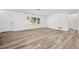 Bright living room with wood-look flooring, a large window, and freshly painted white walls at 1534 Center St, Deland, FL 32720