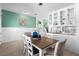A dining room with a table, chairs, a cabinet, wooden floors, and decorative wall accents at 1613 Lady Fern Trl, Deland, FL 32720