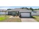 Charming single-story home with a brick-paved driveway, well-manicured lawn, and inviting front porch at 1613 Lady Fern Trl, Deland, FL 32720