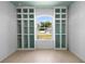 Sun-drenched flex room featuring custom built-in cabinets and a large arched window at 1613 Lady Fern Trl, Deland, FL 32720