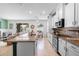 Modern kitchen with stainless appliances and a large island connected to a cozy seating area at 1613 Lady Fern Trl, Deland, FL 32720