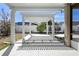 Outdoor pergola featuring a white wooden support structure over a concrete tiled patio at 1613 Lady Fern Trl, Deland, FL 32720