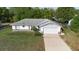 An elevated view of a cozy single-story home with a driveway and fenced yard at 1627 Alloway Dr, Deltona, FL 32738