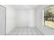 Bright bedroom with tile flooring and large window at 1627 Alloway Dr, Deltona, FL 32738