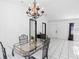 Bright dining area with chandelier and glass-top table, adjacent to living space at 1627 Alloway Dr, Deltona, FL 32738