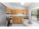 Functional kitchen with stainless steel appliances, light wood cabinets, and breakfast nook at 1627 Alloway Dr, Deltona, FL 32738
