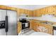 Functional kitchen with stainless steel appliances, light wood cabinets, and breakfast nook at 1627 Alloway Dr, Deltona, FL 32738