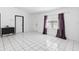 Bright living room with white tile flooring, neutral walls, and natural light from windows at 1627 Alloway Dr, Deltona, FL 32738
