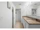 Well-lit bathroom featuring double sinks, granite countertops, and modern white cabinetry at 1655 Pham Dr, Port Orange, FL 32129