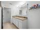 Well-lit bathroom featuring double sinks, granite countertops, and modern white cabinetry at 1655 Pham Dr, Port Orange, FL 32129