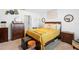 Cozy bedroom featuring a gold comforter, dresser, and an ensuite doorway at 1655 Pham Dr, Port Orange, FL 32129