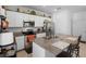 A well-lit kitchen area featuring white cabinets, modern appliances and an island with barstool seating at 1655 Pham Dr, Port Orange, FL 32129