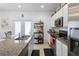 Bright kitchen featuring white cabinets, stainless steel appliances, and granite countertops, creating a modern look at 1655 Pham Dr, Port Orange, FL 32129