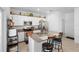 Bright kitchen features a central island with granite countertops, stainless appliances, and white cabinets at 1655 Pham Dr, Port Orange, FL 32129