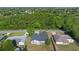 Aerial view of a single-Gathering home surrounded by lush greenery and neighboring houses at 1842 W Cooper Dr, Deltona, FL 32725