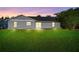 The backyard of this home has a large lawn and a small concrete patio at 1842 W Cooper Dr, Deltona, FL 32725