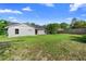 Expansive backyard with lush green grass, a privacy fence, and plenty of room for outdoor activities at 1842 W Cooper Dr, Deltona, FL 32725