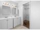 Bathroom featuring dual sinks and a walk-in closet with shelving at 1842 W Cooper Dr, Deltona, FL 32725