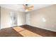 Bright bedroom featuring a ceiling fan, doorway to the bathroom, and neutral-toned walls and flooring at 1842 W Cooper Dr, Deltona, FL 32725