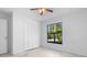Bright bedroom with a window and closet with louvered doors at 1842 W Cooper Dr, Deltona, FL 32725