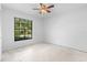 Empty bedroom featuring a window offering natural light and a ceiling fan at 1842 W Cooper Dr, Deltona, FL 32725