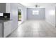 Bright dining area with white tile flooring, and sliding door to patio at 1842 W Cooper Dr, Deltona, FL 32725