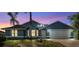 Charming blue single-story home with a two-car garage and manicured front lawn at 1842 W Cooper Dr, Deltona, FL 32725