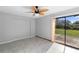 Bright sunroom featuring tile floors, sliding glass doors, and a unique ceiling fan at 1842 W Cooper Dr, Deltona, FL 32725